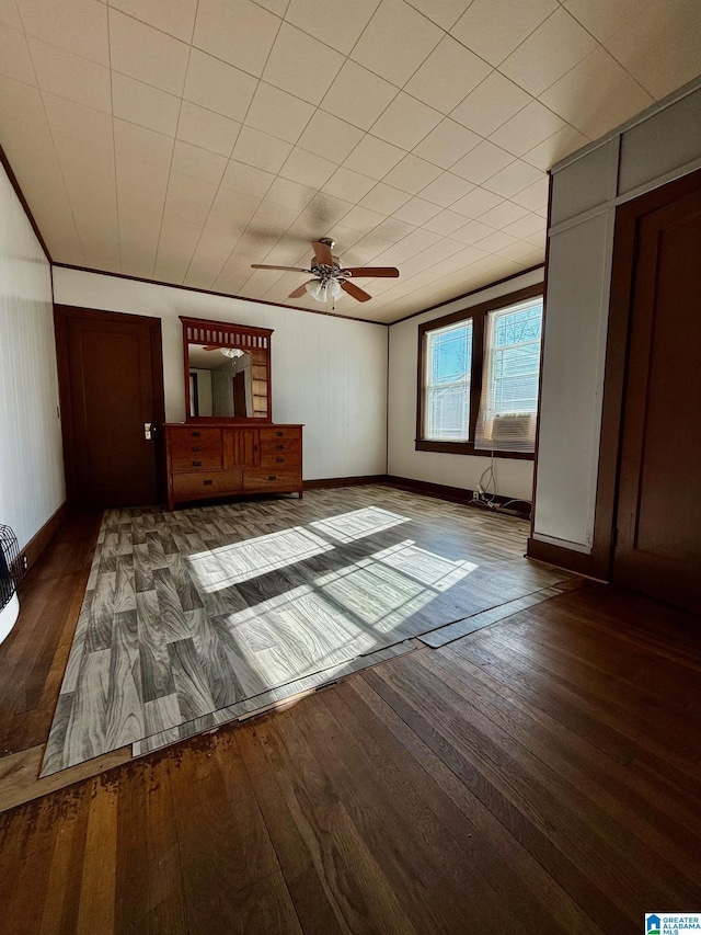 unfurnished bedroom featuring ceiling fan and dark wood-type flooring