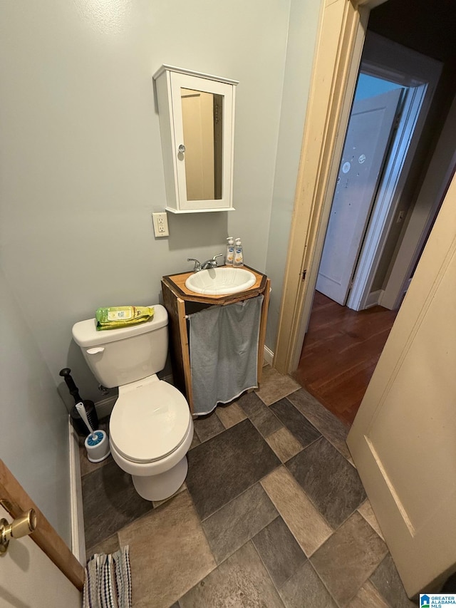 bathroom featuring vanity, toilet, and wood-type flooring