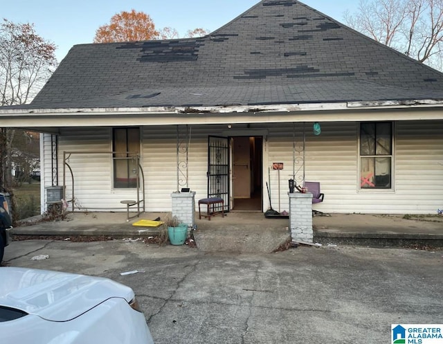 rear view of property with covered porch