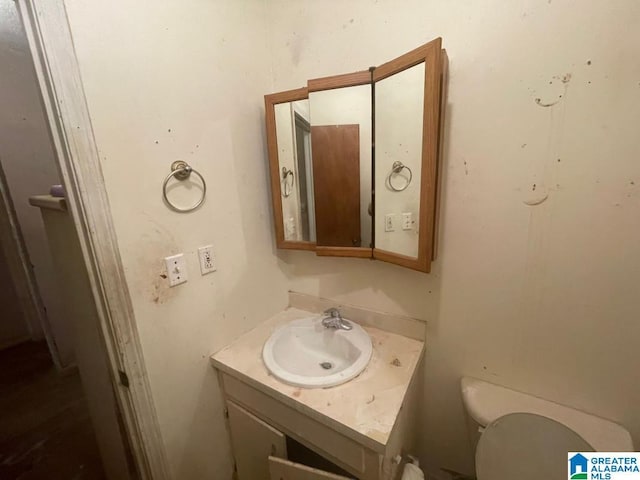 bathroom featuring vanity and toilet