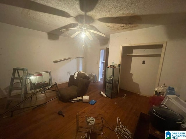 misc room with a textured ceiling and dark wood-type flooring