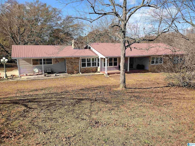 back of house featuring a lawn