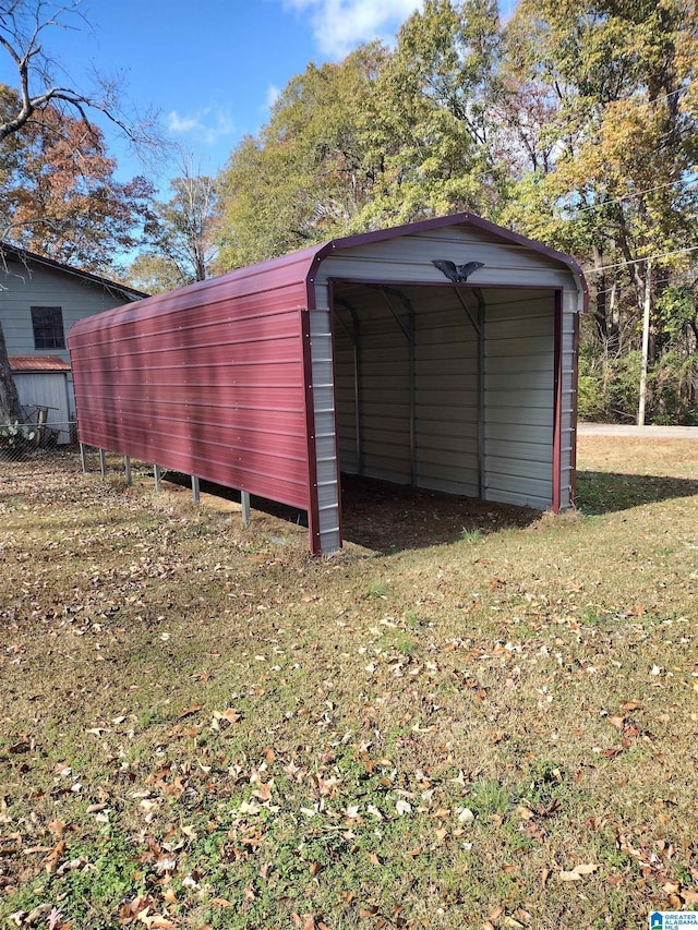 view of outbuilding with a yard and a carport