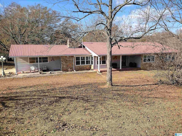 420 Dennis St, Weaver, AL 36277 - back of house with metal roof, stone siding, a porch, and a lawn