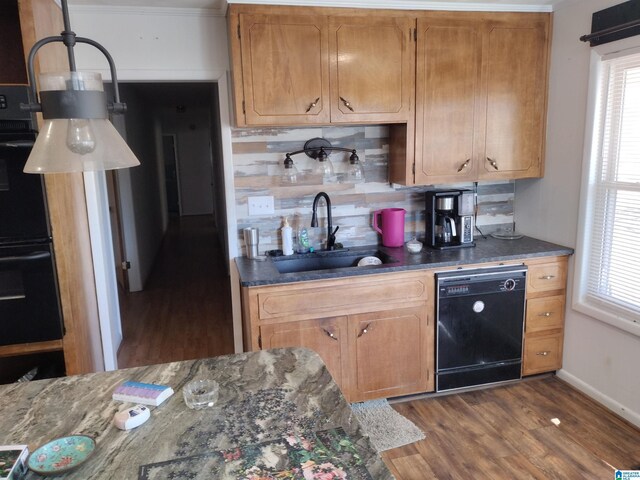 420 Dennis St, Weaver, AL 36277 - kitchen featuring black appliances, a sink, dark wood-style flooring, backsplash, and brown cabinetry