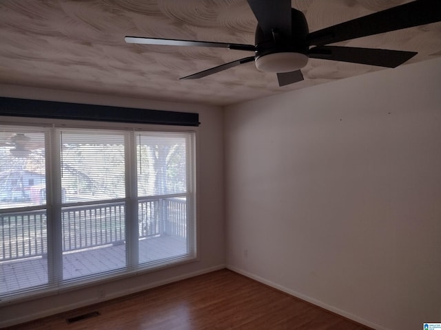 empty room featuring ceiling fan and hardwood / wood-style flooring