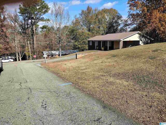 420 Dennis St, Weaver, AL 36277 - view of asphalt road featuring traffic signs