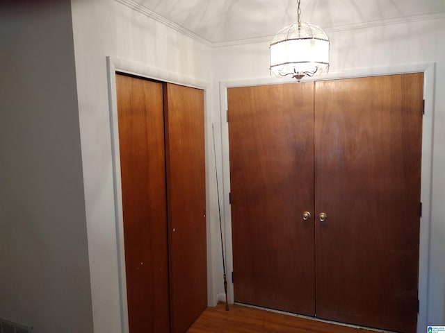 interior space featuring hardwood / wood-style floors and ornamental molding