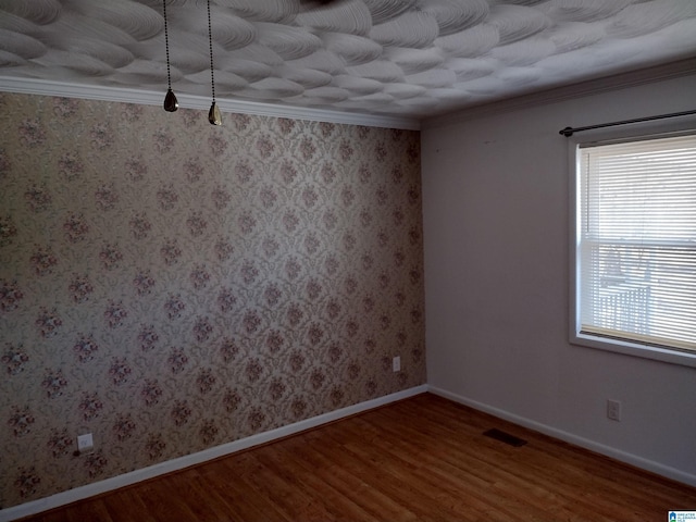 unfurnished room with wood-type flooring and ornamental molding