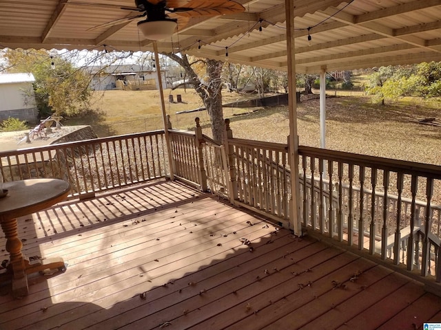 wooden terrace featuring ceiling fan