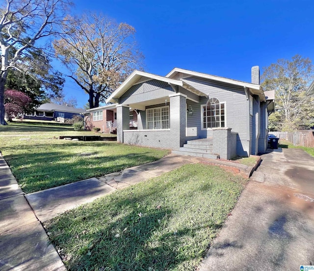 view of front of house with covered porch and a front yard