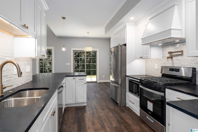 kitchen featuring white cabinets, custom range hood, and appliances with stainless steel finishes