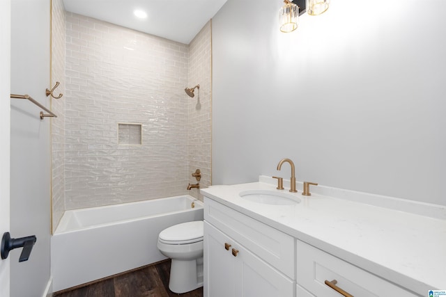 full bathroom with wood-type flooring, vanity, toilet, and tiled shower / bath