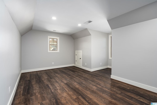 additional living space featuring dark hardwood / wood-style flooring and vaulted ceiling