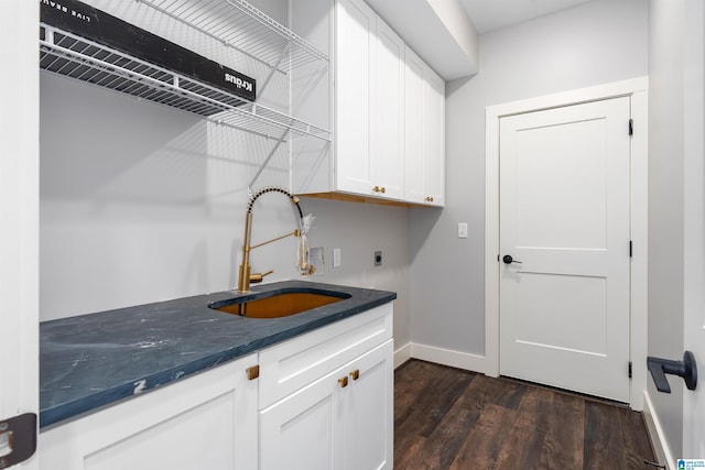 clothes washing area featuring sink, cabinets, dark hardwood / wood-style floors, and hookup for an electric dryer