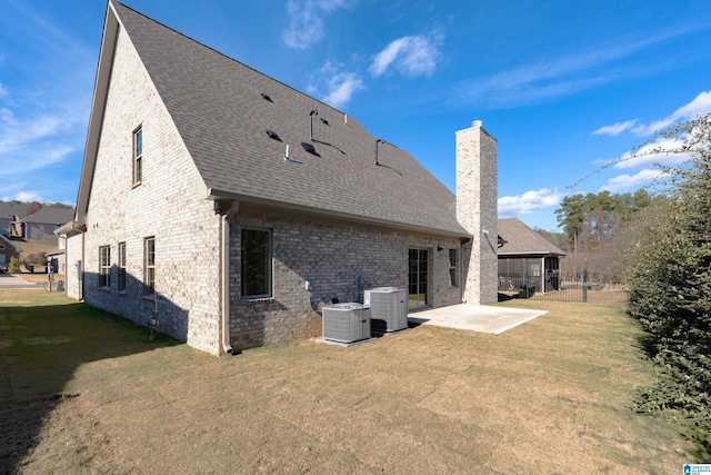 back of property with a yard, central AC unit, and a patio area