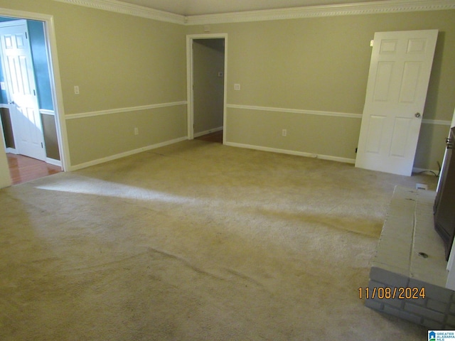 unfurnished room with light colored carpet and crown molding