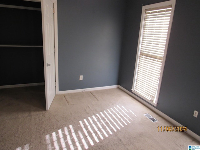 unfurnished bedroom with a closet and carpet floors