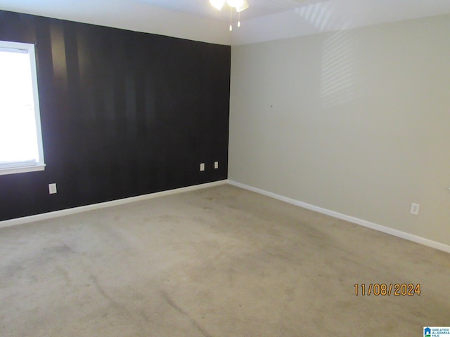 empty room with light carpet and ceiling fan