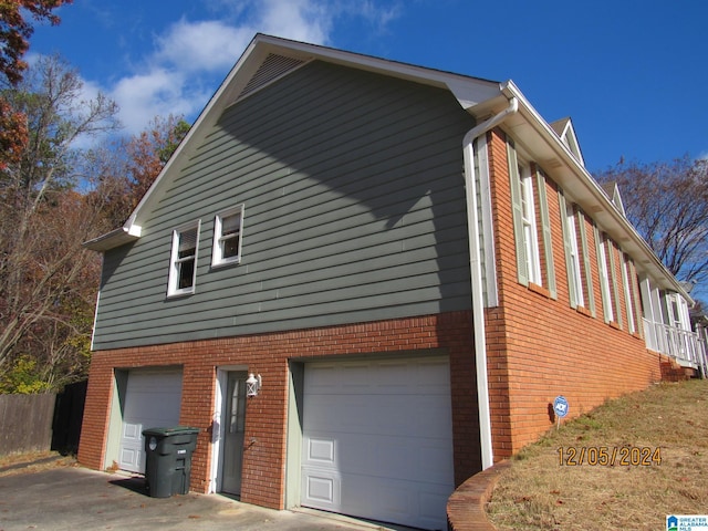 view of side of home featuring a garage