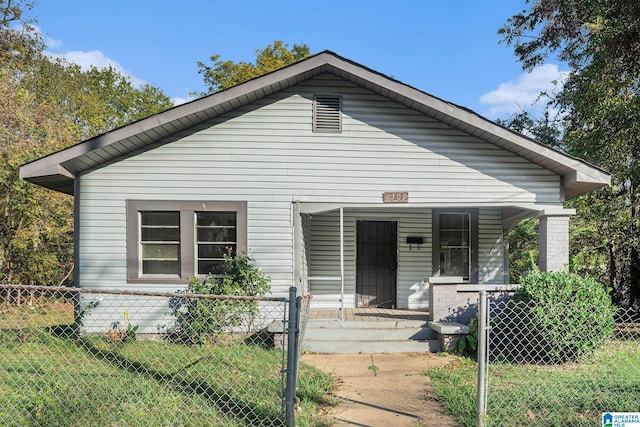 bungalow featuring a front lawn and a porch