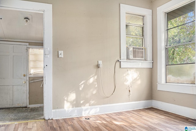 empty room featuring light hardwood / wood-style floors and cooling unit