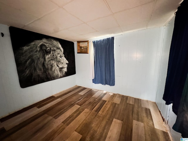501 S Ledbetter St, Anniston, AL 36201 - empty room with wood finished floors and a drop ceiling