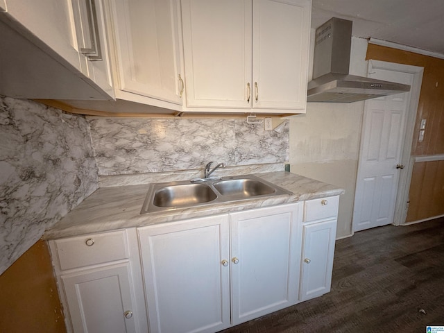 501 S Ledbetter St, Anniston, AL 36201 - kitchen with wall chimney exhaust hood, a sink, decorative backsplash, light countertops, and white cabinetry