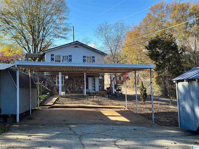 501 S Ledbetter St, Anniston, AL 36201 - view of front of home with a detached carport, asphalt driveway, and stone siding