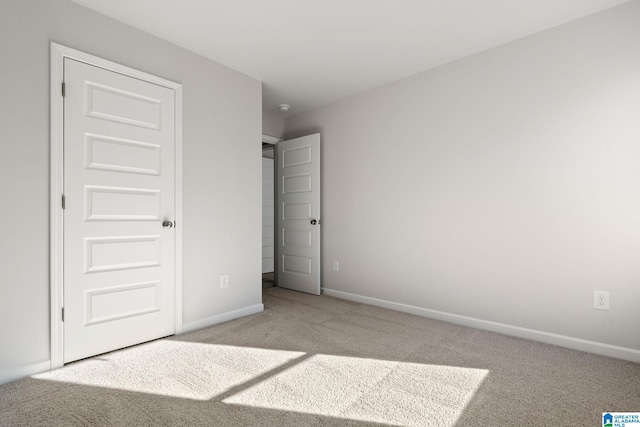 unfurnished bedroom featuring light colored carpet