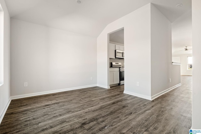 unfurnished living room featuring ceiling fan, dark hardwood / wood-style flooring, and lofted ceiling