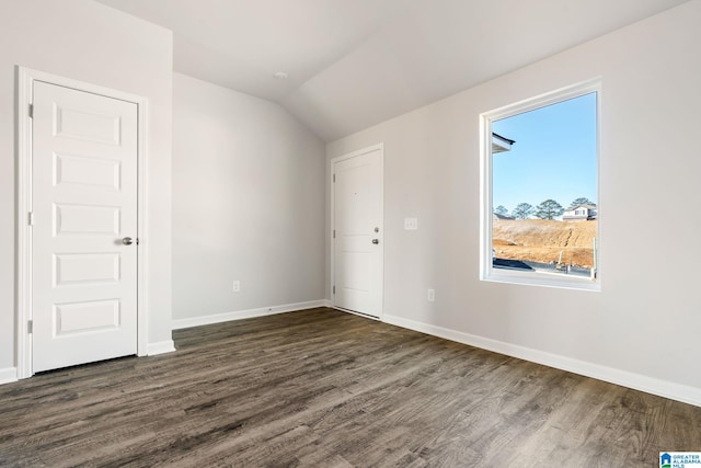 additional living space featuring dark hardwood / wood-style floors and vaulted ceiling