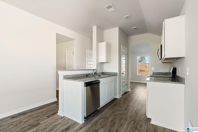 kitchen with vaulted ceiling, sink, white cabinetry, stainless steel appliances, and stone countertops