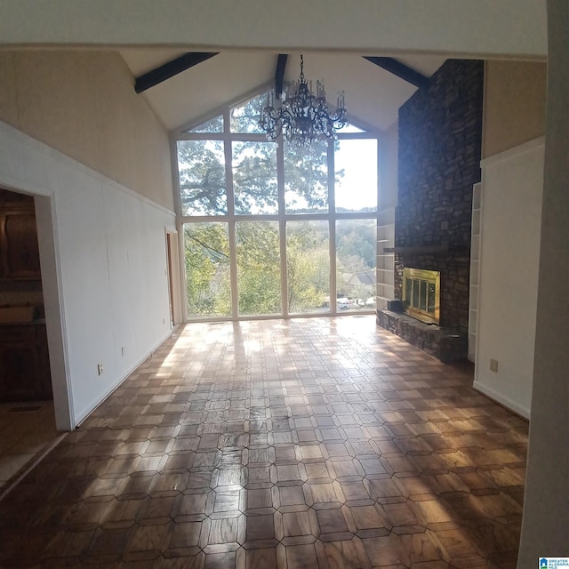 unfurnished living room with beamed ceiling, a fireplace, and high vaulted ceiling