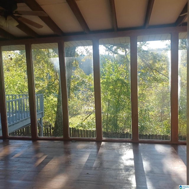 unfurnished sunroom with ceiling fan