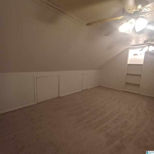 additional living space featuring carpet flooring, ceiling fan, and vaulted ceiling