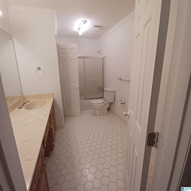 full bathroom featuring vanity, shower / bath combination with glass door, tile patterned floors, toilet, and ornamental molding