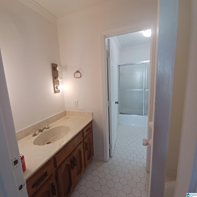 bathroom with crown molding, tile patterned flooring, and vanity