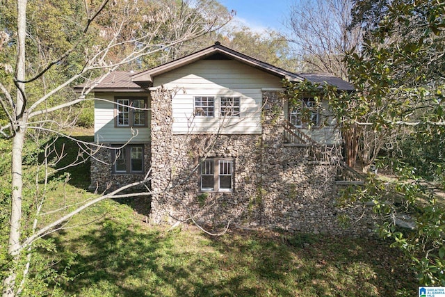 view of home's exterior with a yard