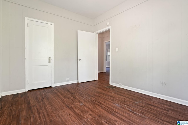 unfurnished bedroom featuring dark wood-type flooring