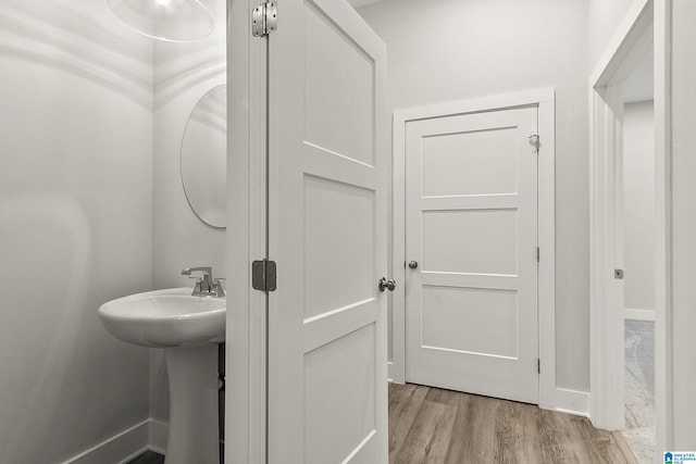 bathroom featuring baseboards and wood finished floors