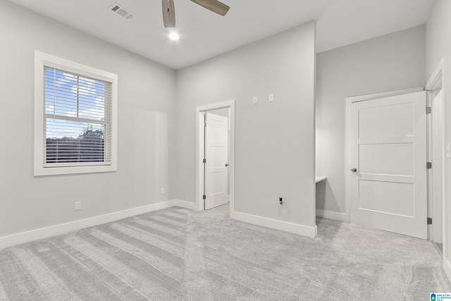 unfurnished bedroom with carpet floors, baseboards, visible vents, and a ceiling fan