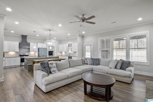 living area featuring baseboards, ornamental molding, dark wood-type flooring, and recessed lighting