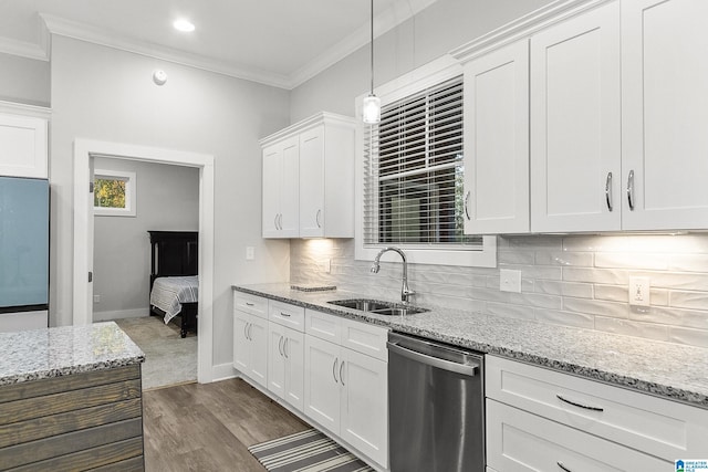 kitchen featuring a sink, white cabinets, ornamental molding, appliances with stainless steel finishes, and decorative backsplash