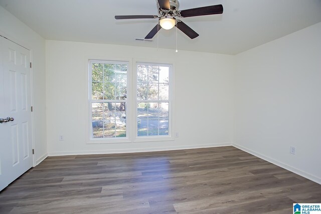 unfurnished room with ceiling fan and dark hardwood / wood-style floors