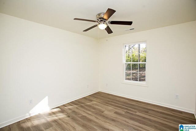 empty room featuring hardwood / wood-style floors and ceiling fan