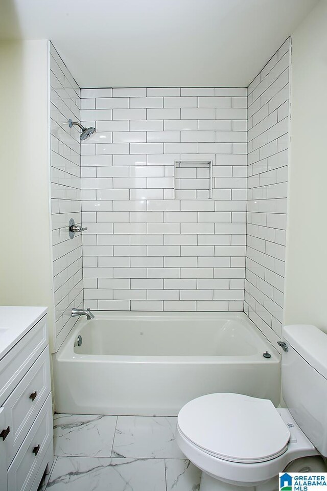 full bathroom featuring vanity, toilet, and tiled shower / bath combo