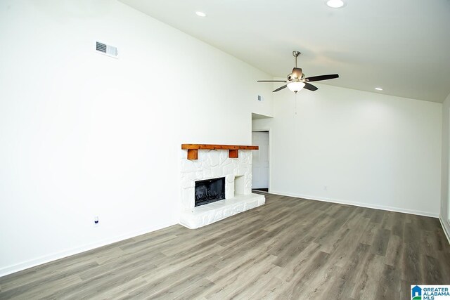 unfurnished living room with ceiling fan, a fireplace, high vaulted ceiling, and hardwood / wood-style flooring