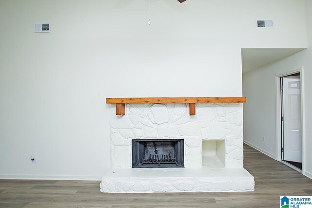 room details featuring hardwood / wood-style floors, ceiling fan, and a fireplace