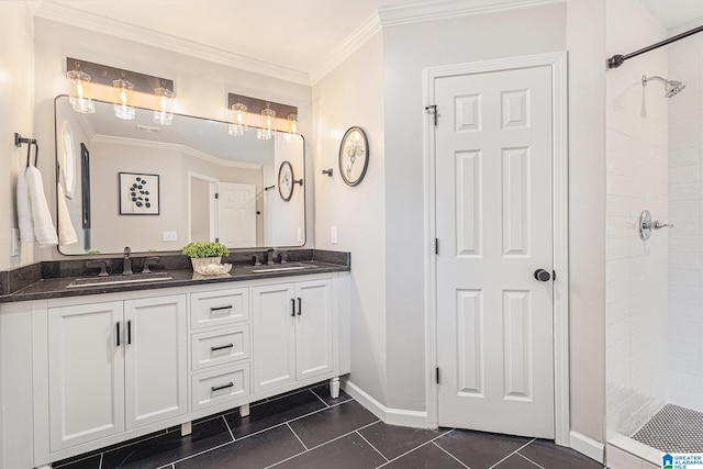 bathroom featuring tile patterned flooring, vanity, tiled shower, and crown molding